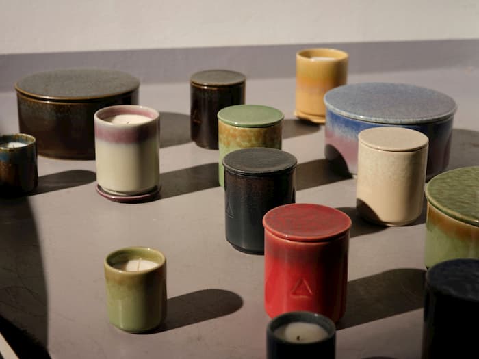 selection of candles in ceramic jars
