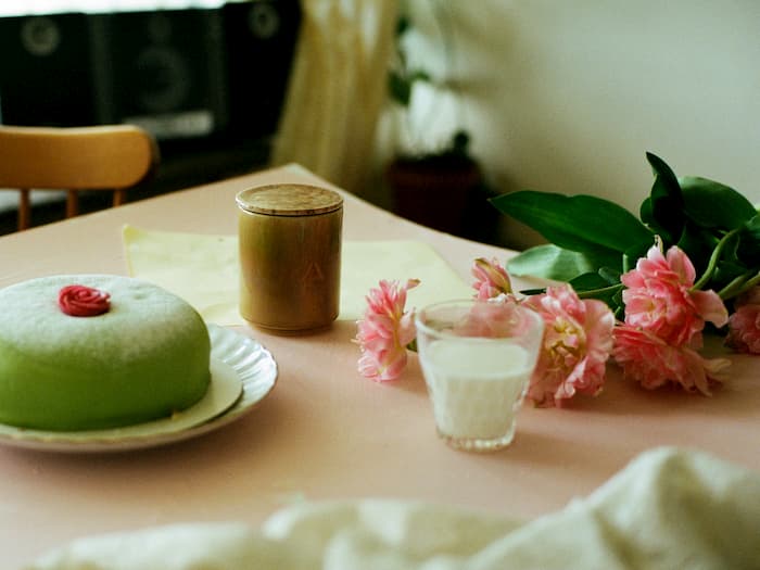 kitchen table with a cake and candle