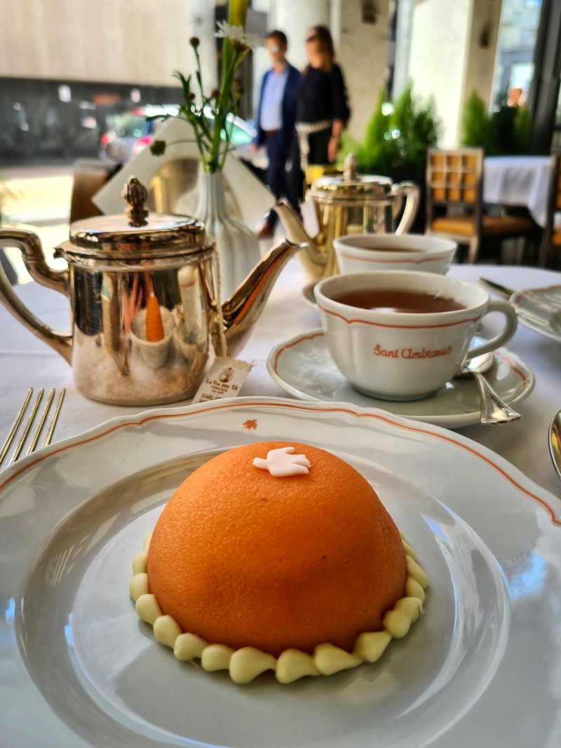 orange round cake on a plate in a cafe in Milan