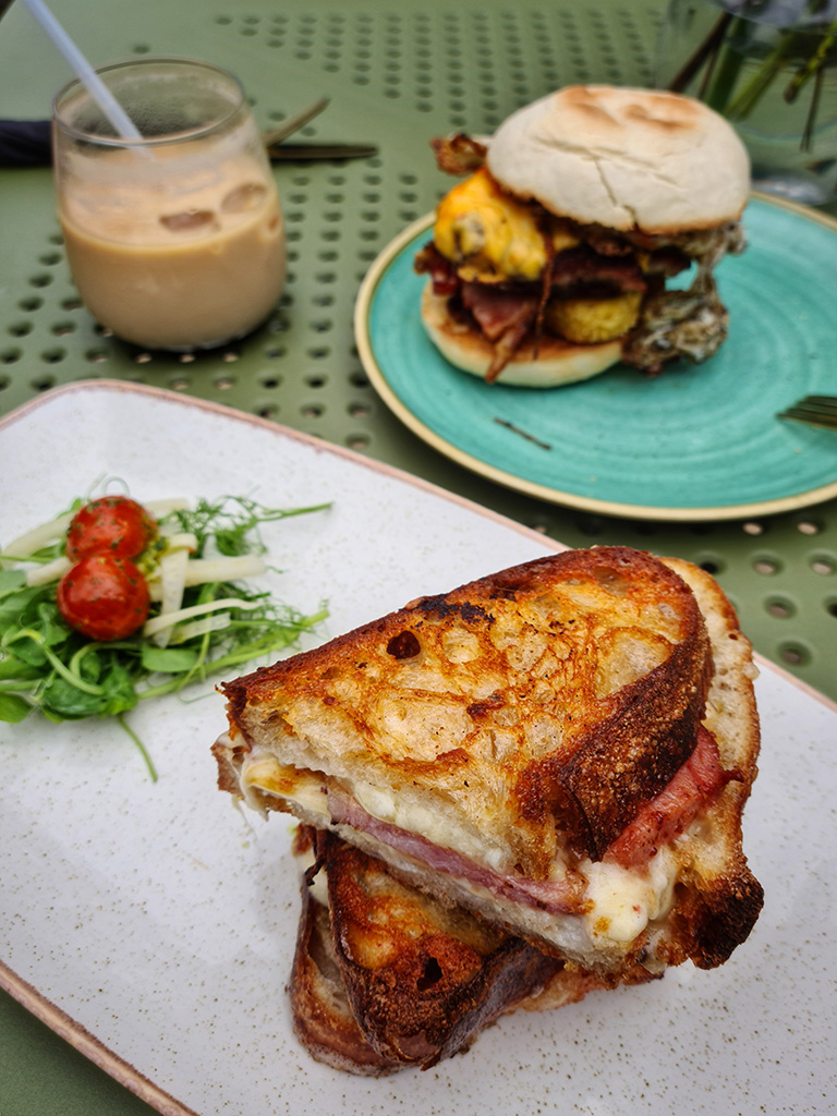 grilled cheese sandwich and breakfast muffin on a table