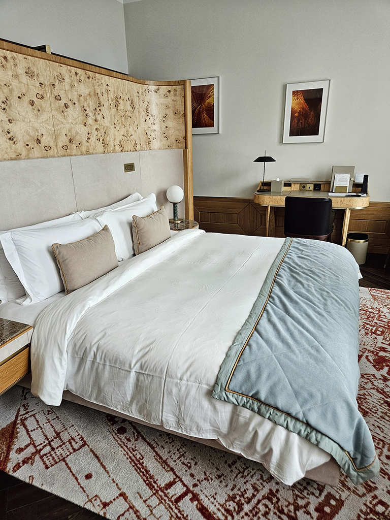 king-size bed with a decorative headboard in a hotel room